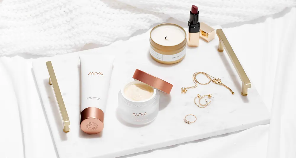 AVYA cleanser and moisturizer on a marble tray